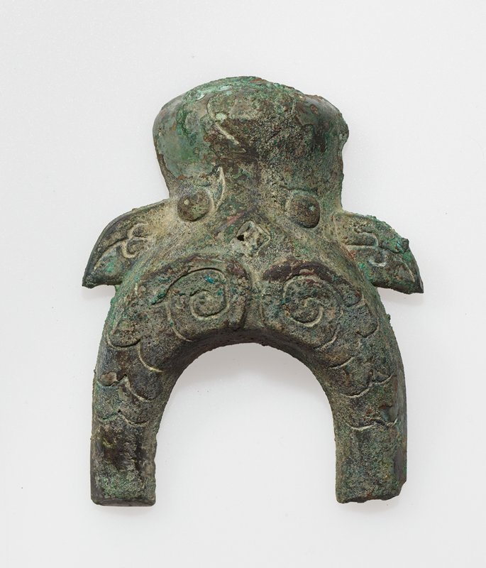 Appliqué in the in the form of a bovine head, one of a pair