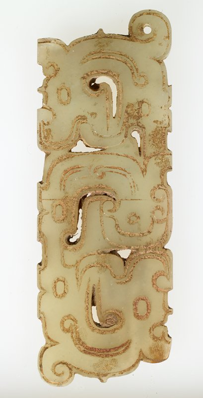 Pendant in the form of a man flanked by a pair of dragons
